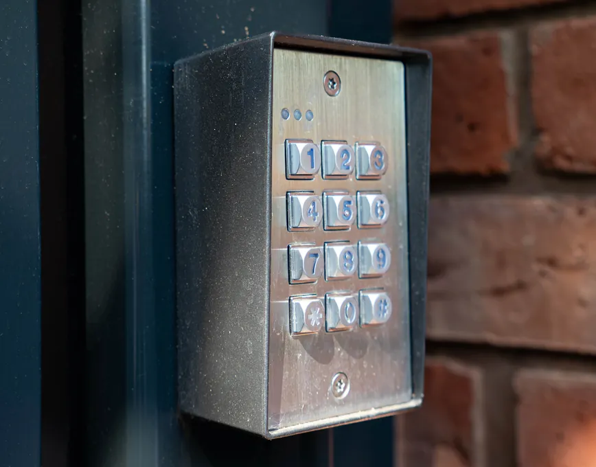 Keypad entry beside an aluminium driveway gate, Solihull