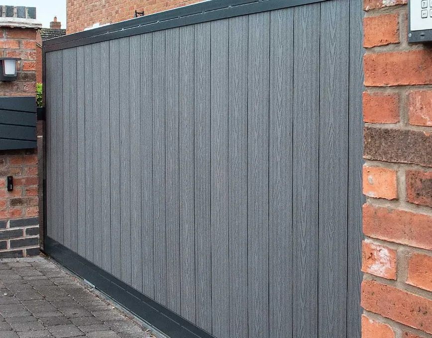 Grey composite driveway gate with keypad entry