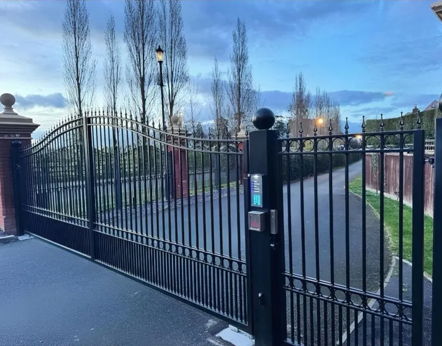Automated black steel swing gates with railed tops