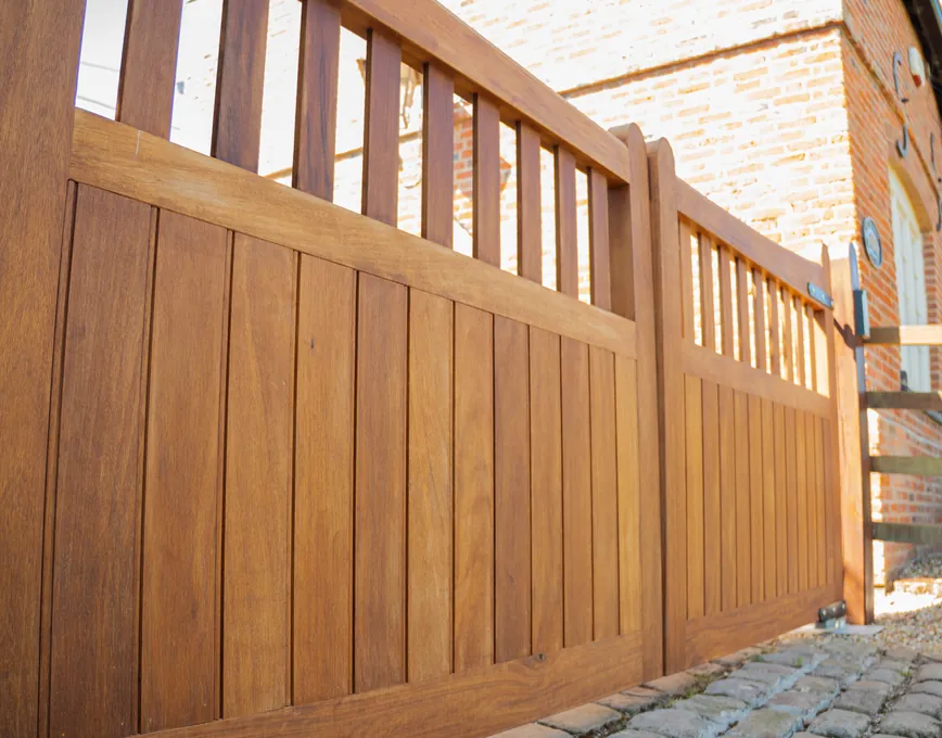 Close-up of hardwood boards and railed top on a timber gate