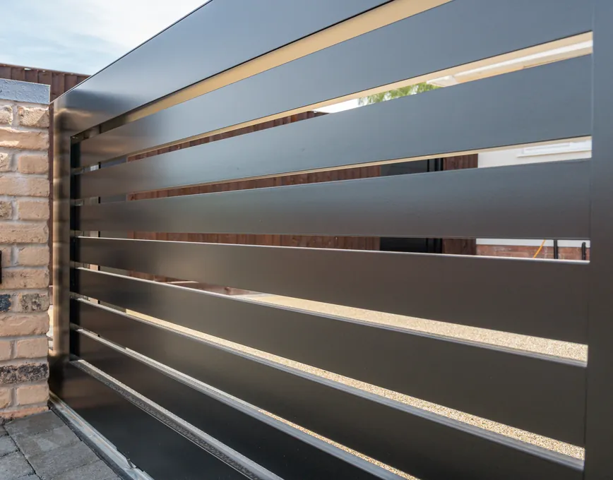 Close-up of the black slats of a sliding gate