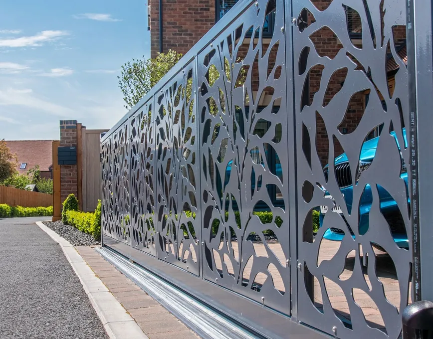 Laser-cut steel sliding gate with a leaf pattern