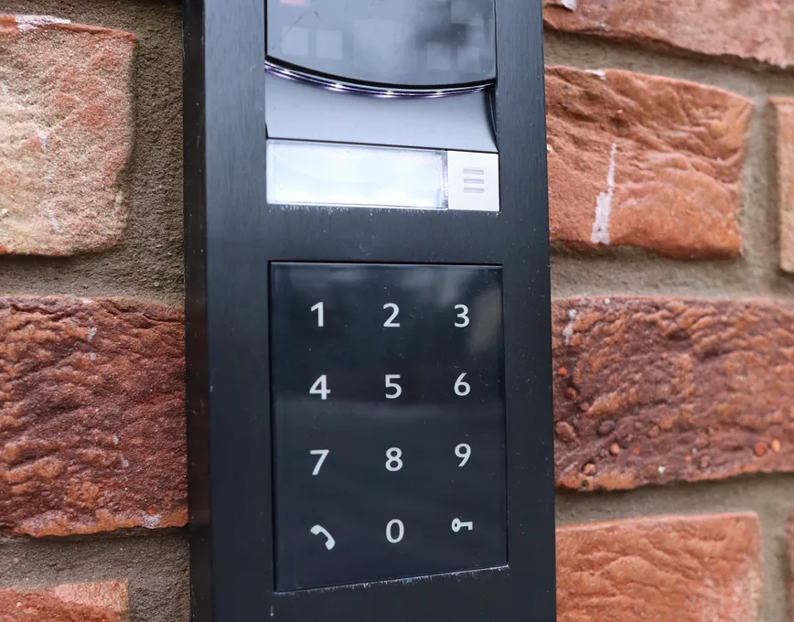 Video intercom with keypad set into a brick gate pier
