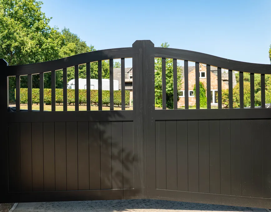Black traditional swing gates with a curved railed top, Blackwell
