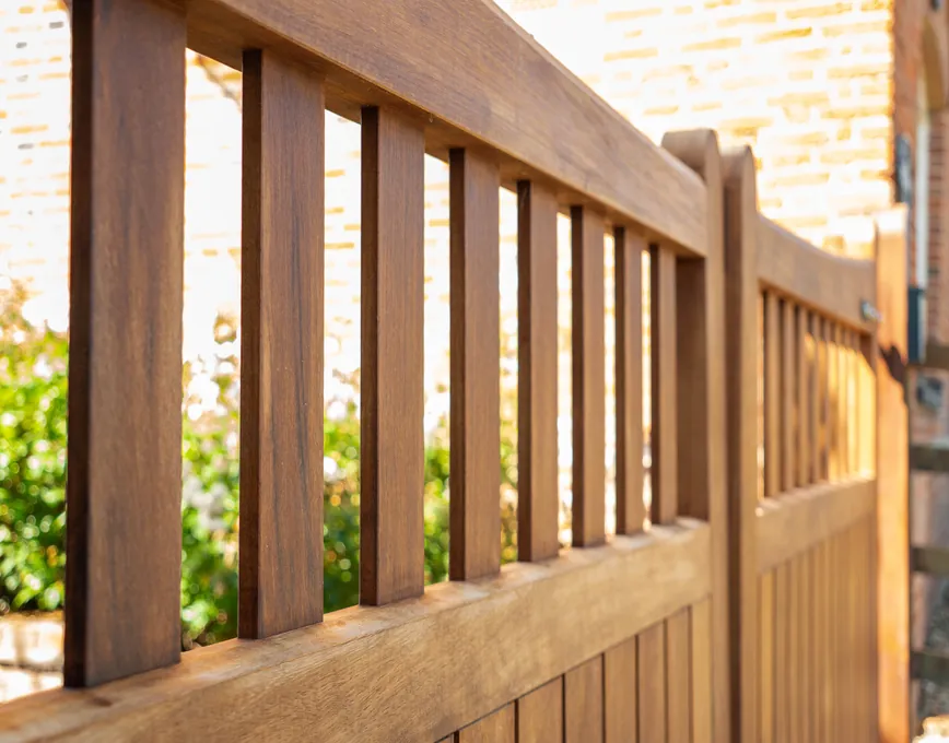 Close-up of the railed top of a timber driveway gate