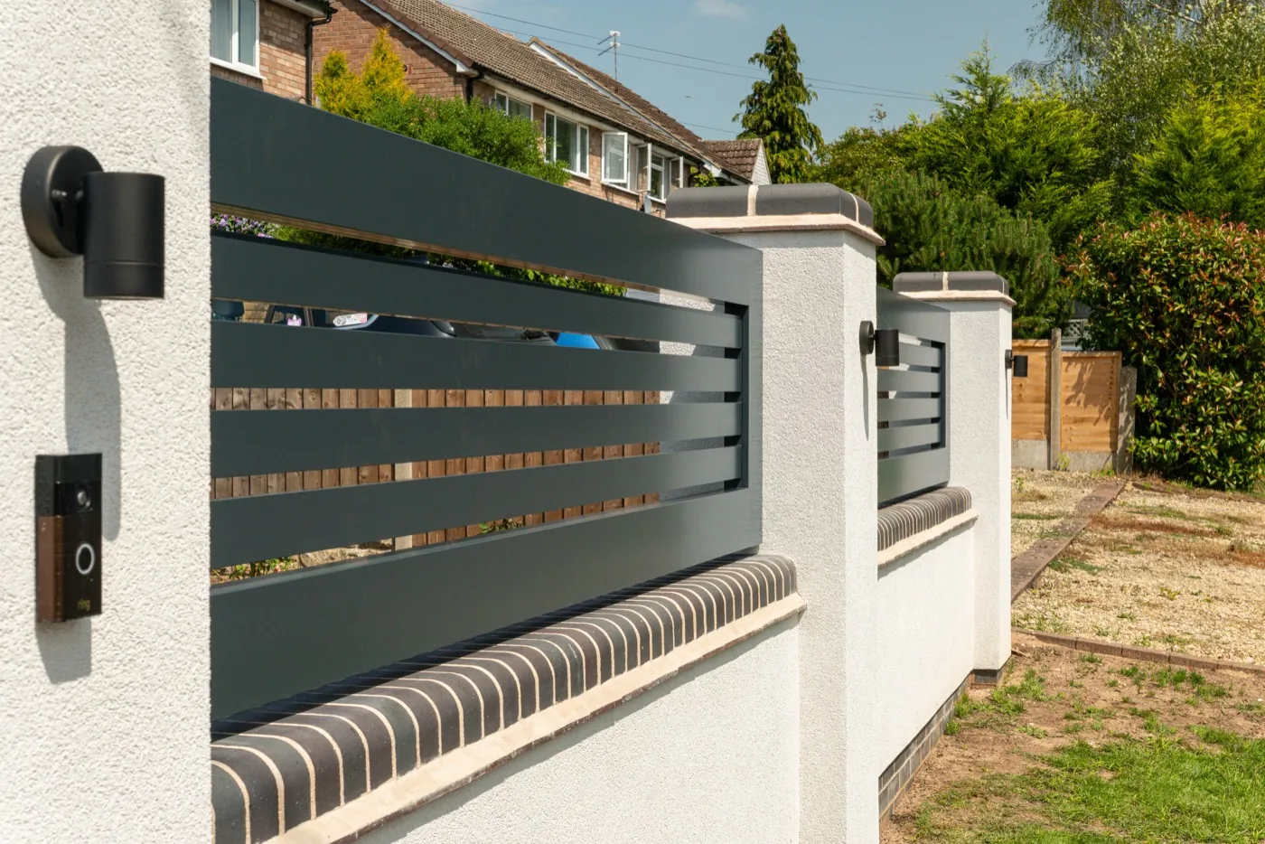Aluminium slat gate detail with a wall-mounted intercom, near Redditch