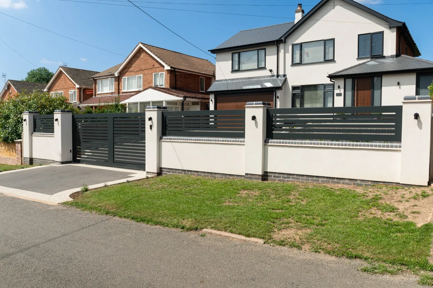 The full frontage with the aluminium slat gate, near Redditch
