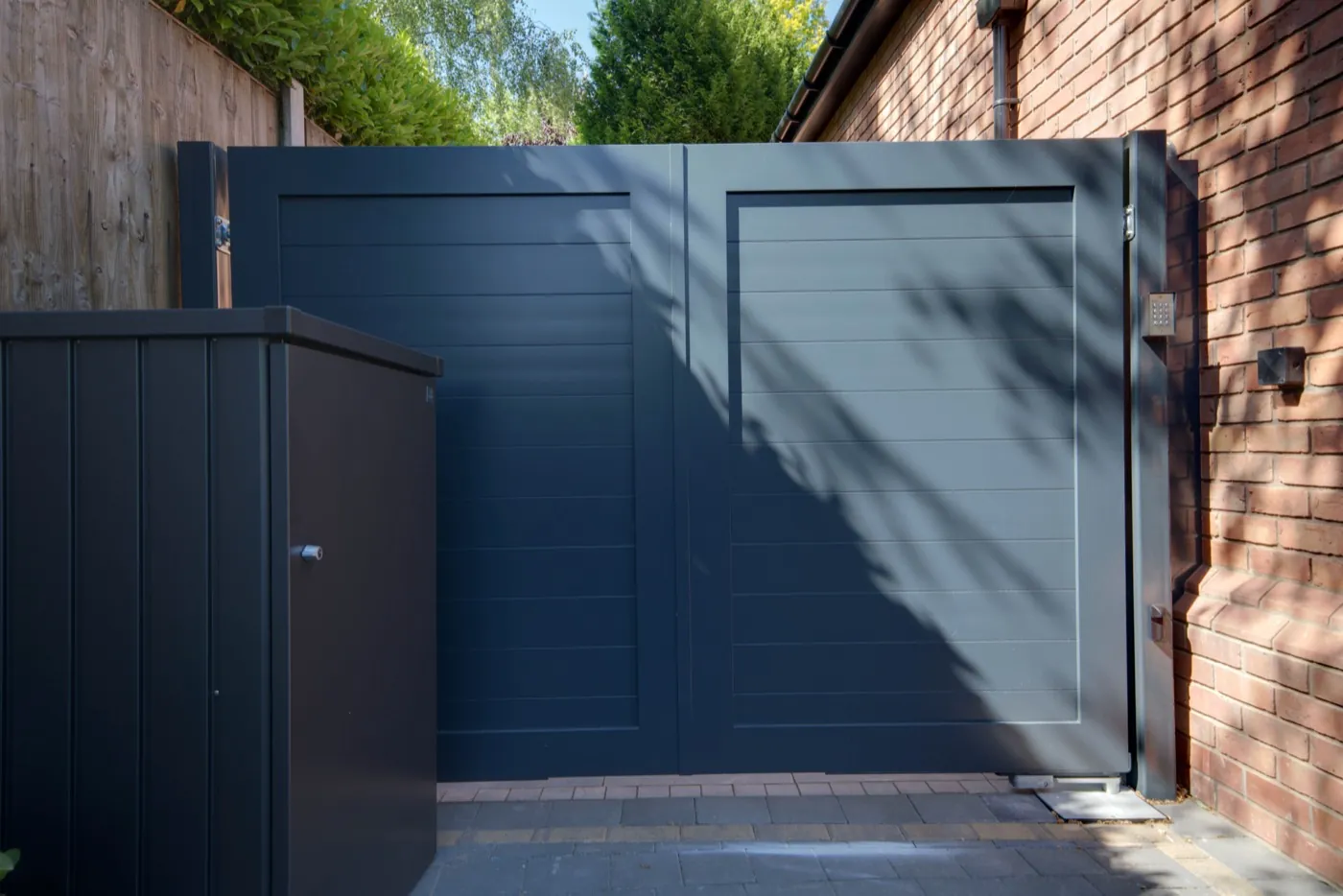 Anthracite aluminium sliding gate in sunlight, Solihull