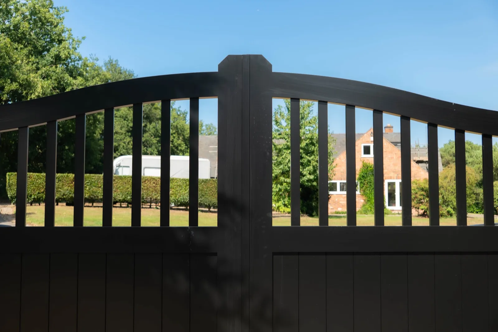 Close-up of the arched top and spindles of the black gates