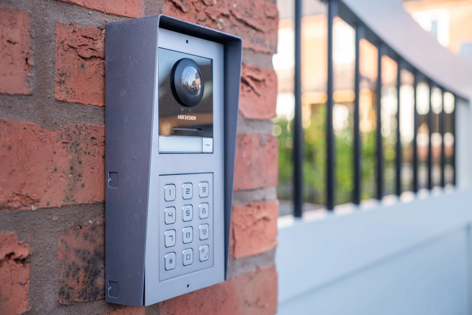Video intercom with keypad mounted on a brick gate pier