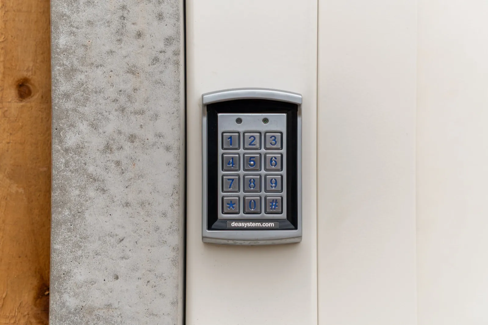Keypad entry beside a cream gate